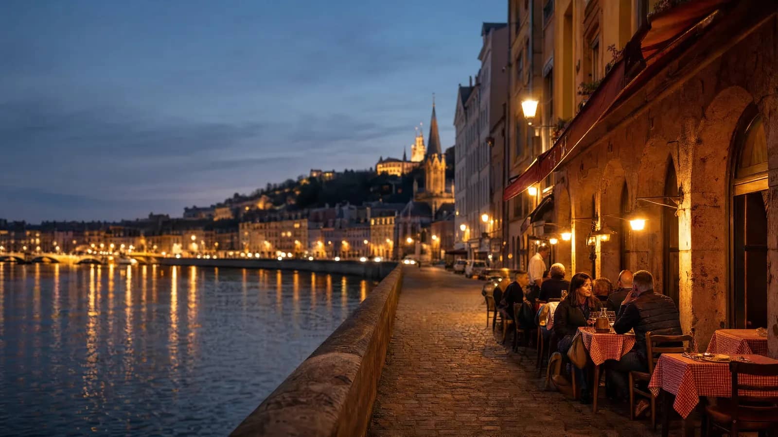 La Saône au crépuscule à Lyon, terrasse de bouchon éclairée dans le Vieux Lyon
