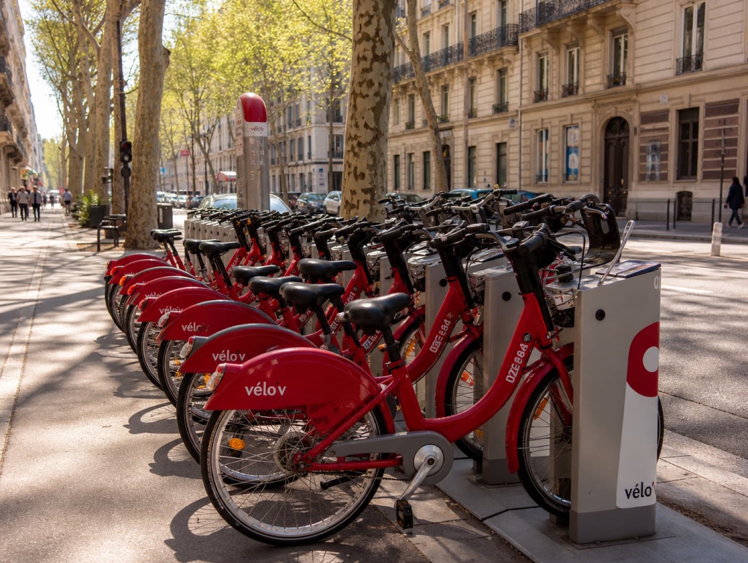 Station de vélos en libre-service rouges sur un trottoir lyonnais